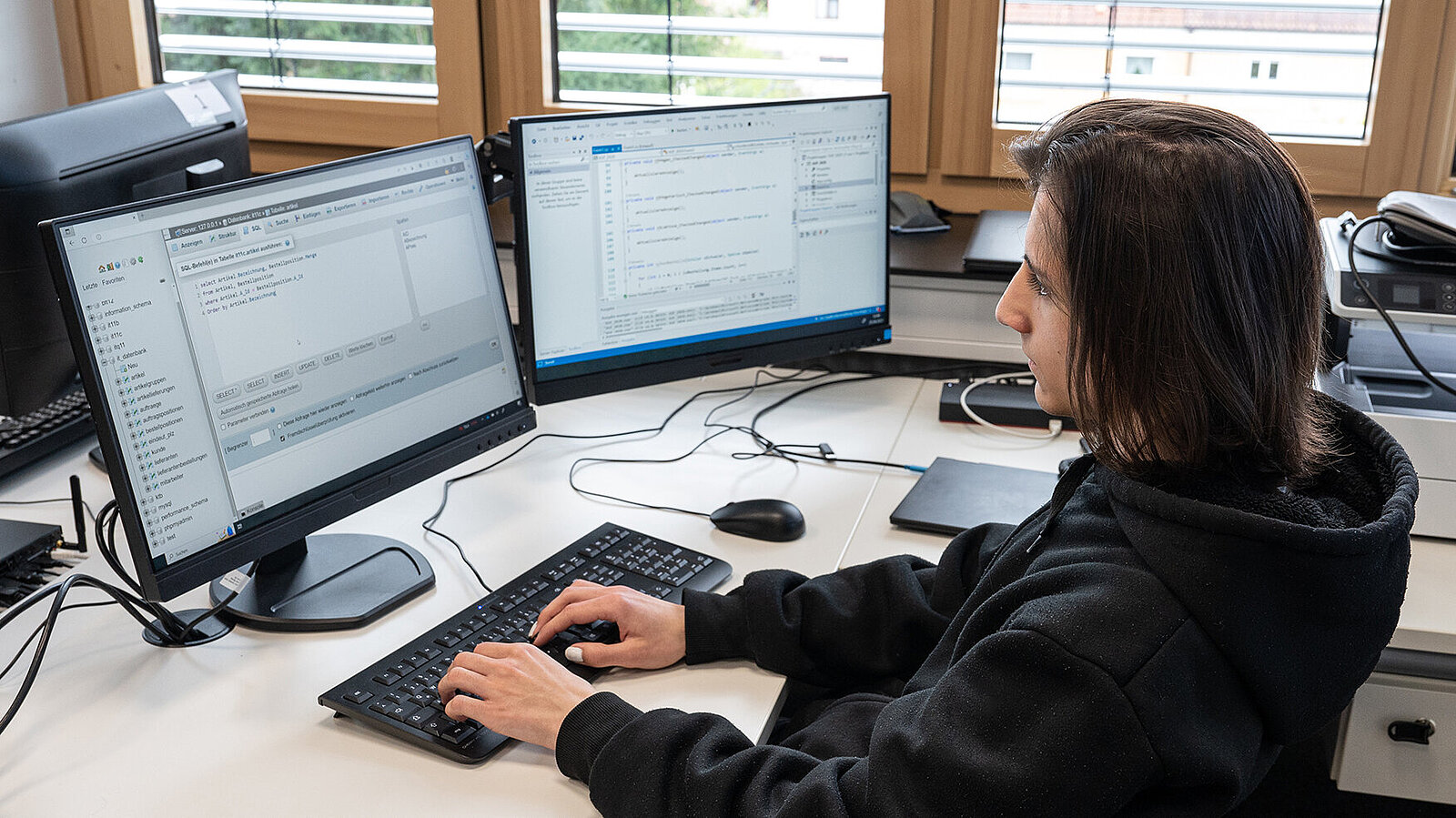 Ein junger Mann arbeitet am Computer in einem Büro.