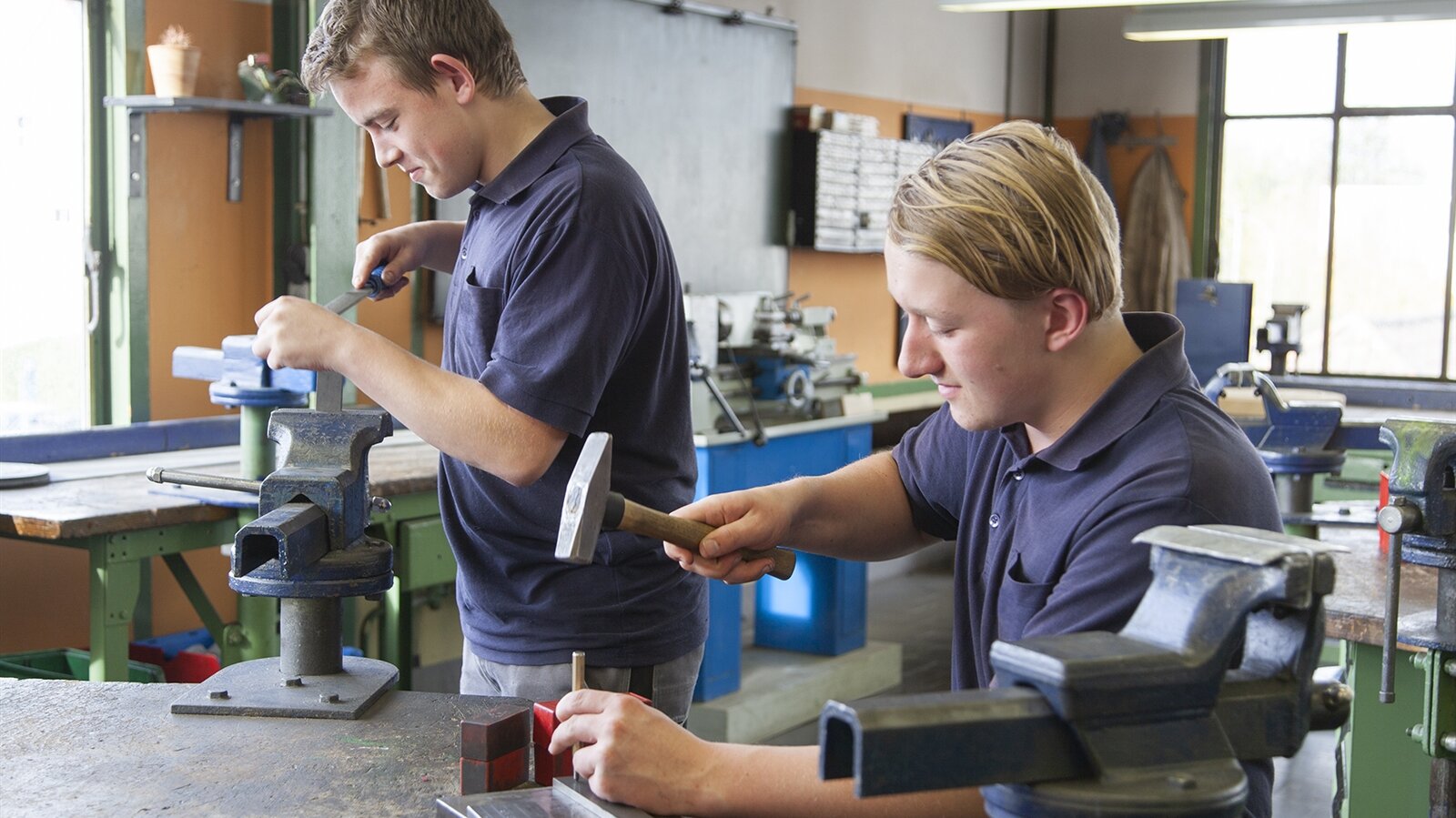 Andy und Patrick üben in der Ausbildungswerkstatt die Metallverarbeitung.